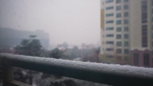Snowy cityscape with tall buildings