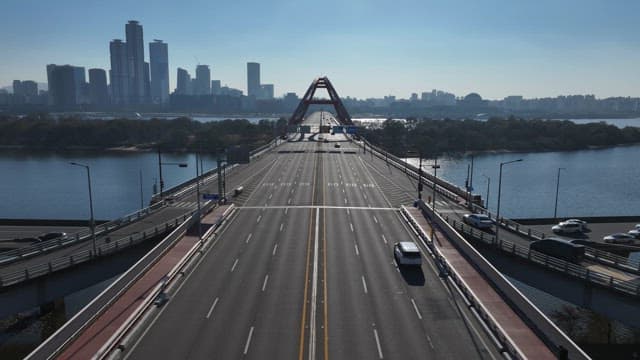 Sunlit Bridge Over Hangang River with Urban Skyline