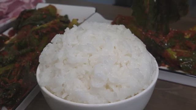 White rice topped with fresh leaf mustard kimchi