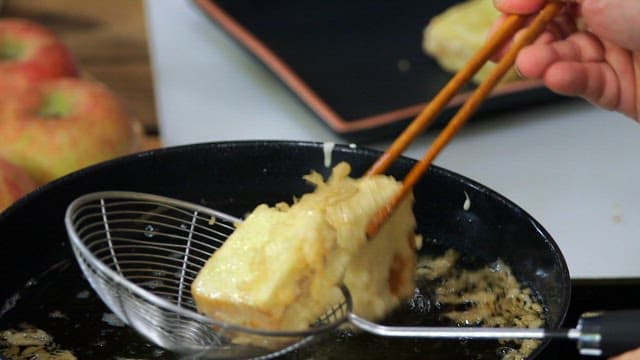 Bread slices frying in hot oil