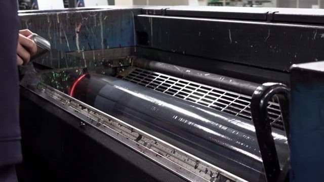 UV lamp shines on a large industrial fluorescent ink printer