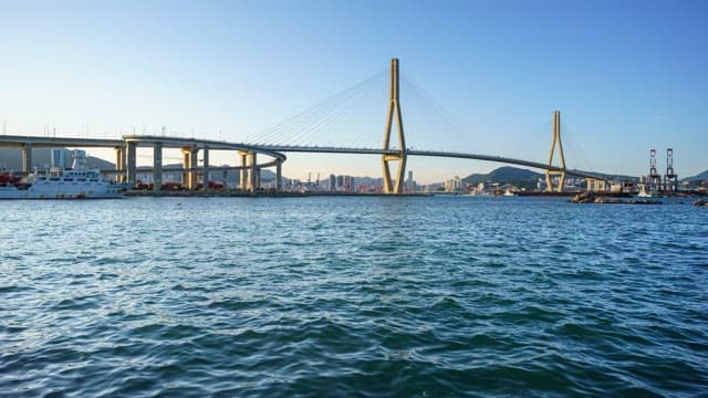 Busy Busanhangdaegyo Bridge and serene sea from day to night