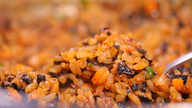 Spoonful of Korean fried rice with seaweed and vegetables