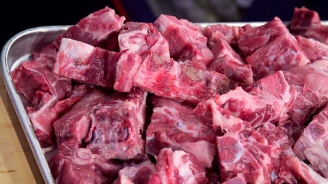 Raw meat pieces on a metal tray