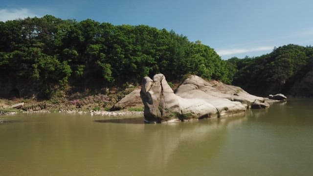 Big rock by a quiet river