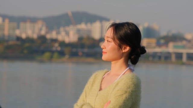Woman posing for a photo by the river
