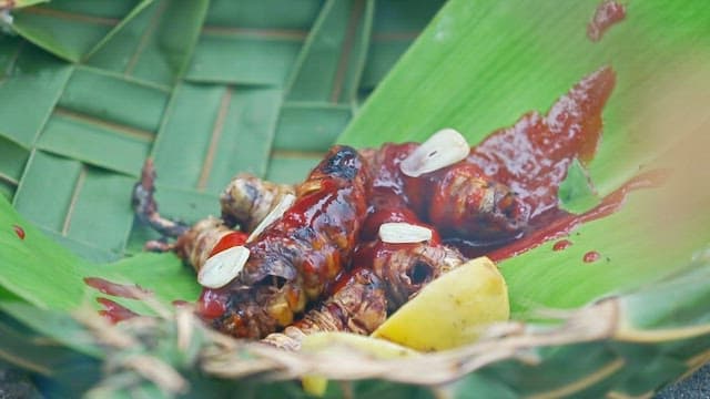 Grilled insects with sauce and lemon