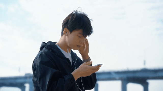 Young man listening to music outdoors