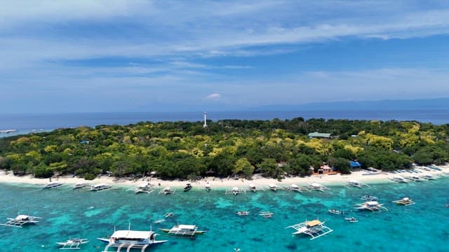Tropical island with boats and clear water