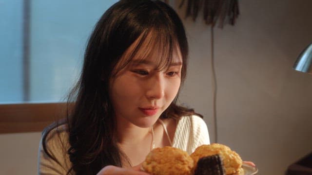 Woman enjoying a plate of desserts indoors