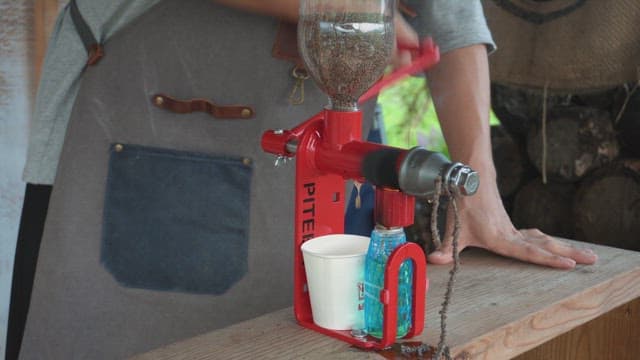 Hand pressing oil from seeds using a machine