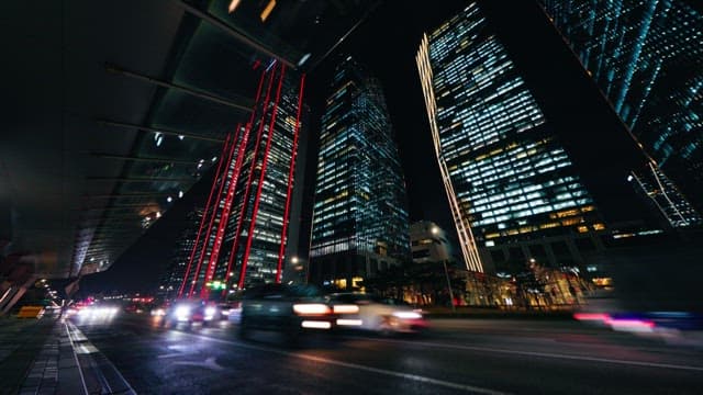 Nighttime city traffic with illuminated skyscrapers