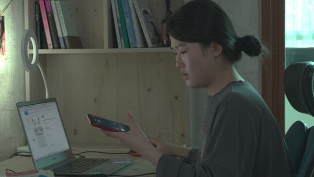 Woman talking on cell phone in her room at home