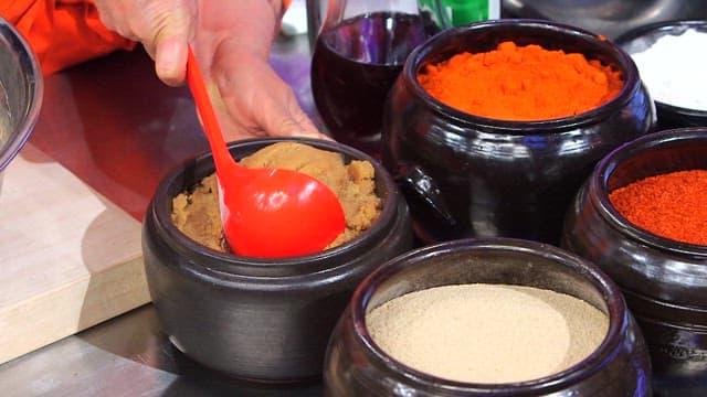 Putting soybean paste in a big container
