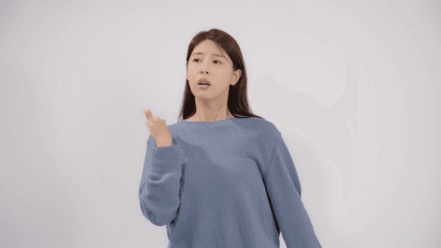 Woman fanning herself with her hand