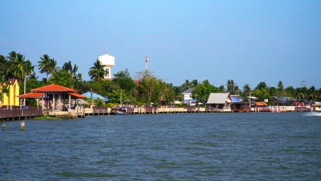 Tropical trees and floating houses along the riverside