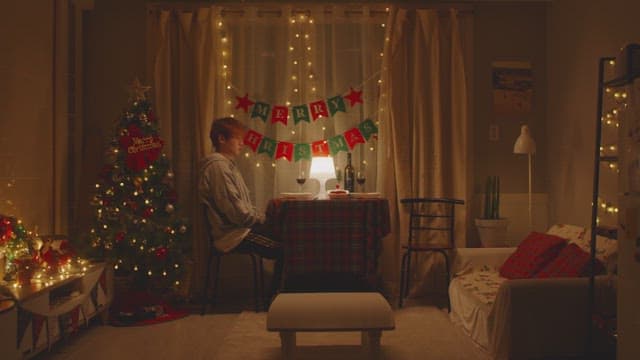 Man eating in cozy room decorated with Christmas decorations