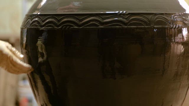 Pottery Craftsman Carving a Pattern on a Earthenware