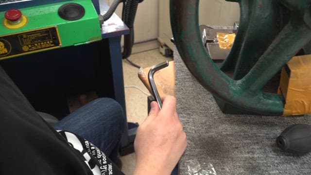Person working with metal tools indoors