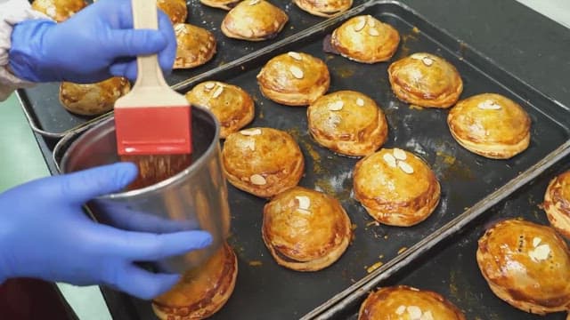 Glazing freshly baked bread to make it glossy