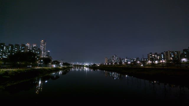 Night view of a city with river reflections