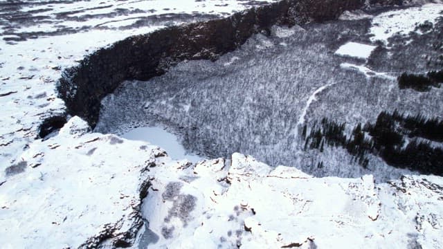 Snow-covered landscape with cliffs