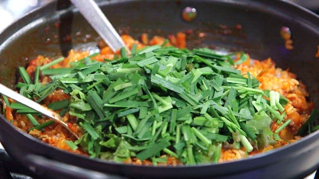 Fried rice and vegetables stir-fried in a pan