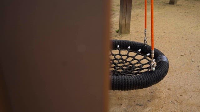 Empty Swing Hanging in a Playground