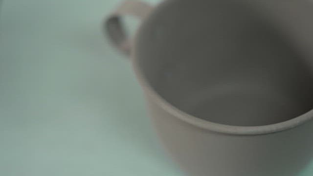 Blurry close-up shot of a gray cup