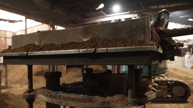 Industrial machinery processing soil