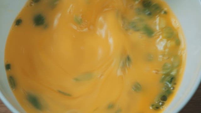Mixing Egg Mixture and Green Onions in a Bowl