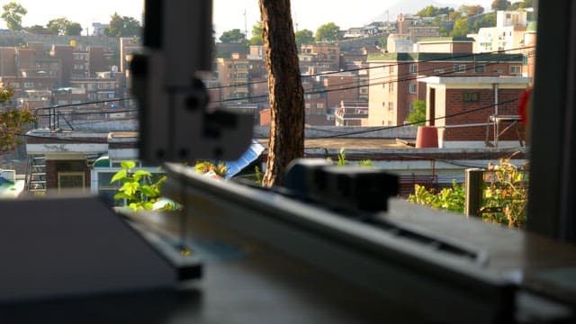 Industrial machine with cityscape in the background
