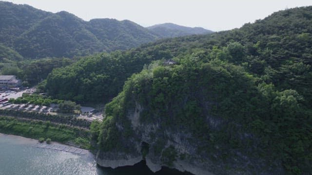 Serene Lake by Lush Green Mountainside