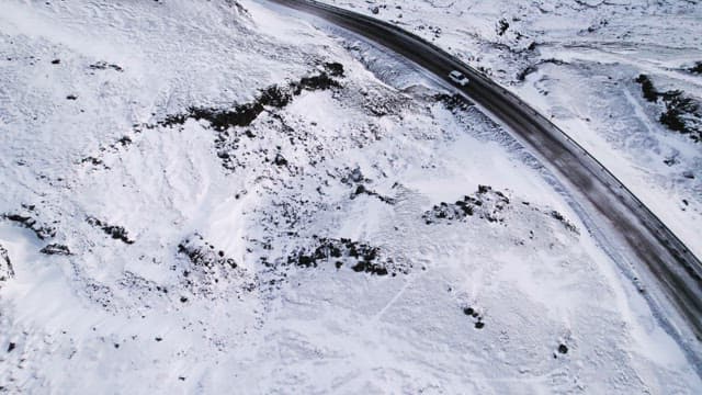 Car driving on a snowy mountain road