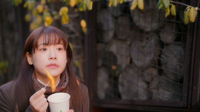 Student eating tteokbokki in winter