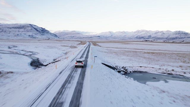 Car driving on a snowy road in winter