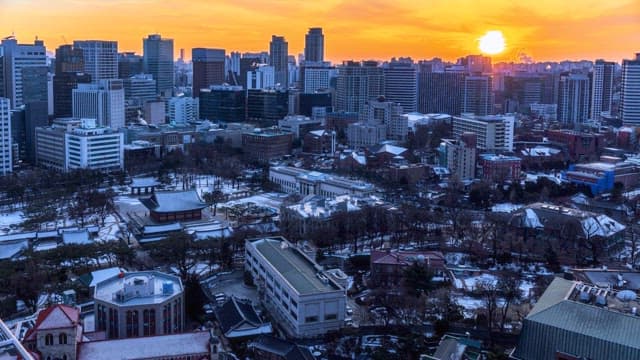 Cityscape transitioning from sunset to night