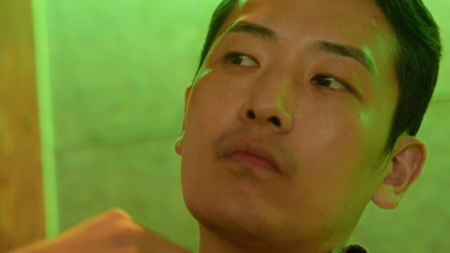 Man in a green-lit room