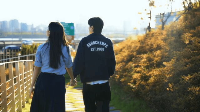Couple walking hand in hand on a sunny day