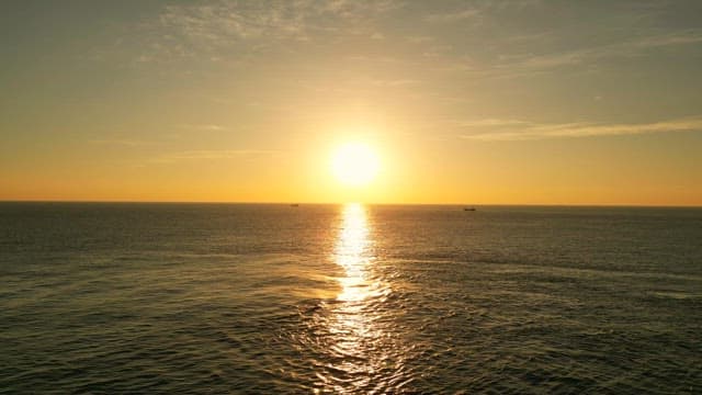 Sunset over the calm ocean horizon