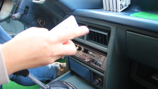 Putting a tape into a car cassette