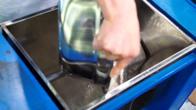 Mixing ingredients in a blue container