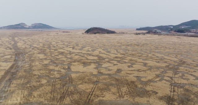 Vast field with distant hills