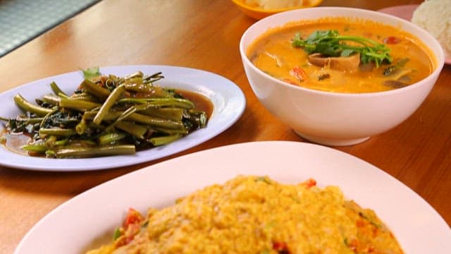Among the various Thai dishes on the table, Poo Phad Pong Curry