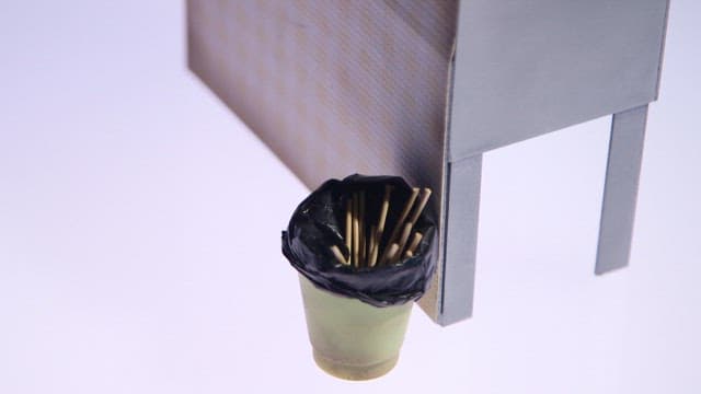 Diorama depicting a street food stall with skewered dishes