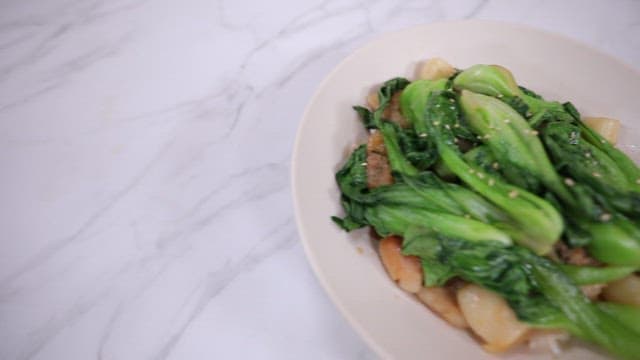 Plate of stir-fried bok choy and pork with garlic