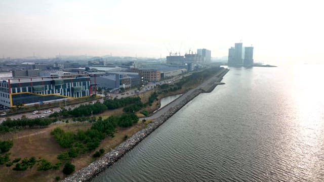 Industrial Complex by the Water with Bright Sun Shining