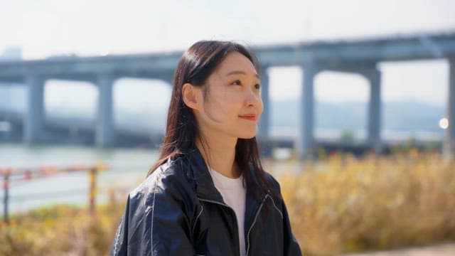 Woman enjoying music by the riverside