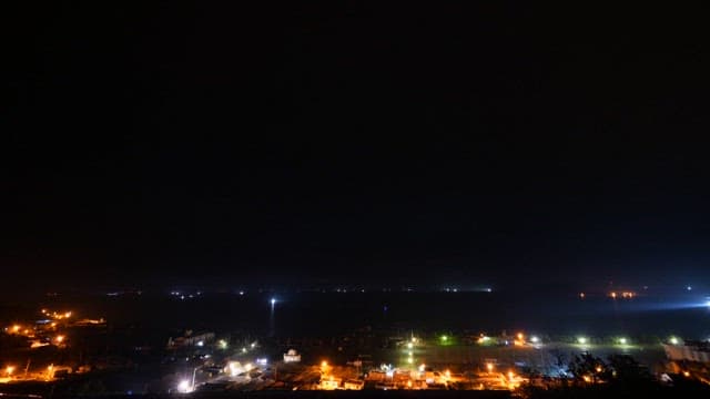 Seascape near the port transitioning from night to dawn