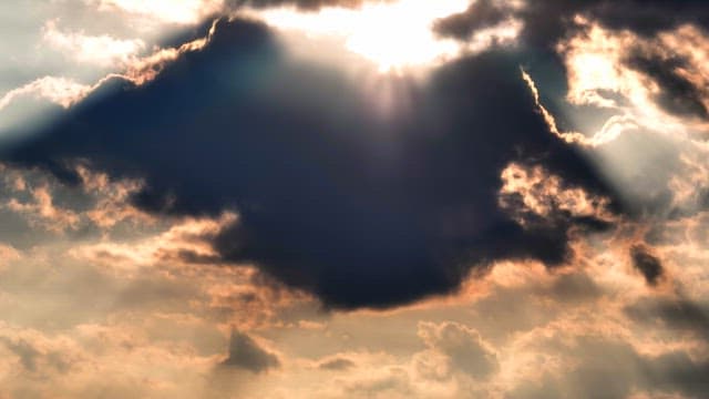 Sunlight streaming through dark clouds
